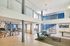 Contemporary loft-style apartment with open floor plan, stylish metal screens, blue accent walls, and modern furnishings.