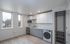 Contemporary kitchen with sleek cabinetry, modern appliances, and abundant natural light from large windows.
