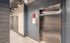 Modern apartment lobby with sleek elevator access and contemporary lighting design for convenience and style.
