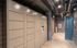 Sleek, modern apartment mailroom featuring secure parcel lockers and polished concrete floors, exuding convenience and style.