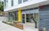 Modern apartment entrance with sleek glass facade and vibrant yellow accents at 1446.