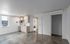 Modern urban studio with stylish concrete floors, compact kitchen, and laundry area.