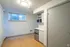 Chic and modern kitchenette with sleek cabinetry, compact fridge, and microwave, enhanced by natural light and stylish flooring.