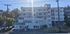 Inviting modern apartment building, offering 1, 2, and 3-bedroom units for lease, nestled in a lush green neighborhood.