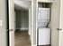 Chic apartment with an integrated laundry unit in a sleek, modern hallway.