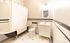Charming bathroom with vintage clawfoot bathtub, elegant black and white tiling, and bright vanity area for a classic look.