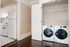 Chic apartment showcasing modern laundry setup with washer and dryer adjacent to a compact yet stylish kitchen.