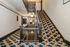 Elegant apartment stairway with intricate, patterned carpet, creating a luxurious and welcoming ambiance.
