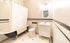 Charming bathroom with vintage black-and-white aesthetics, featuring a clawfoot bathtub and elegant tile flooring.