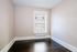 Bright and airy room with expansive window and gleaming hardwood floors, perfect for a cozy bedroom or stylish home office.