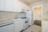 Bright and modern kitchen with sleek white cabinetry, stainless steel appliances, and elegant marble countertops.