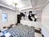 Modern apartment lobby featuring stylish geometric flooring, a striking map mural, and contemporary lighting.