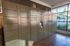 Modern apartment common area featuring secure package lockers with natural lighting from large windows.