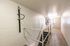 Modern stairwell with bike storage, featuring sleek metal railings and efficient wall-mounted racks, perfect for urban living.