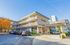 Contemporary apartment complex with stylish balconies, modern architecture, and convenient parking in a vibrant urban setting.