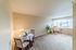 Bright living space with cozy dining nook, plush carpeting, and large windows inviting natural light.