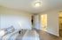 Bright bedroom with plush carpeting, modern lighting, and ensuite bathroom offering comfort and style.