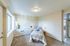 Bright and cozy bedroom with a large window, plush carpet, and stylish decor, perfect for relaxation and comfort.