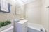 Bright and modern bathroom with a sleek white vanity, elegant lighting, and a fresh, clean ambiance.