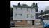 Charming apartment building with modern design, ample windows, and inviting entryway, offering great accessibility and urban living convenience.