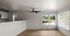 Bright and airy living space with modern ceiling fan and stunning outdoor views, adjacent to a sleek open kitchen.