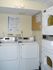 Modern laundry room featuring efficient coin-operated washers and dryers, perfect for hassle-free living.