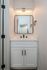 Modern bathroom vanity with sleek lighting and elegant mirror in a stylish apartment.