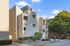 Contemporary apartment complex with unique architectural design and lush greenery, offering a vibrant living experience.