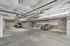 Spacious and secure underground parking garage featuring ample parking spaces and modern lighting.