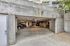 Spacious and secure underground parking garage with ample lighting and multiple parking spaces.