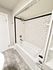 Chic bathroom featuring elegant subway tile design, modern fixtures, and a luxurious bathtub.