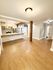 Inviting open-concept living space with a modern kitchen, wooden floors, and elegant lighting.