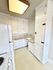 Bright and charming kitchen featuring vintage white cabinetry, ample storage space, and a cozy countertop area.