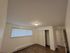 Bright and spacious bedroom with elegant flooring, large window, and ample closet space in a modern apartment.