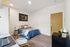 Contemporary bedroom with stylish decor, featuring a cozy bed, modern artwork, and a compact workspace, ideal for relaxation and productivity.