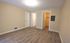 Bright and spacious room with modern wooden flooring, neutral walls, and walk-in closet, perfect blank canvas for a personalized touch.