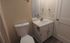 Elegant bathroom featuring a sleek vanity with modern fixtures and ample storage space.