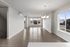 Inviting open-concept living space featuring elegant hardwood floors, large windows with scenic views, and a modern chandelier.