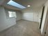 Bright, airy room with plush carpeting, skylight, and natural light perfect for a cozy retreat.