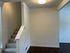 Welcoming entryway with elegant carpeted stairs and modern lighting, leading to open living spaces.
