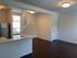 Bright and modern open-concept living area with sleek stainless steel appliances in a stylish kitchen.