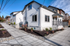 Charming residential street view showcasing modern houses with fresh landscaping and inviting front porches.