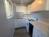 Charming kitchen with bright cabinetry, modern appliances, and ample natural light from a large window.