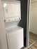 Compact in-unit laundry with modern stacked washer and dryer in a sleek apartment setting.