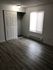 Inviting bedroom with sleek wood flooring, ample closet space, and abundant natural light.