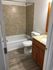 Contemporary bathroom with elegant granite accents, sleek fixtures, and easy-to-maintain flooring.