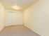 Bright and spacious room with plush carpet, neutral walls, and ample closet space for convenient storage.