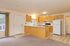 Bright and welcoming kitchen with modern appliances, spacious countertops, and charming wooden cabinetry.