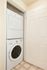 Efficient laundry area featuring a sleek, stackable washer and dryer set within a compact closet space.