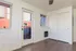 Bright room with elegant wooden flooring, modern sliding closet doors, and a private balcony access.